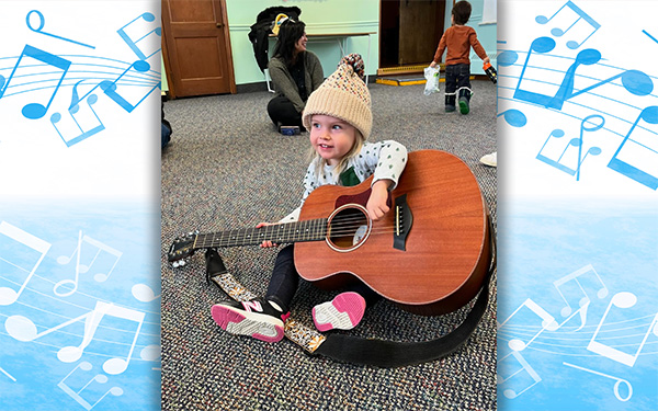 Photograph of a young girl playing a guitar