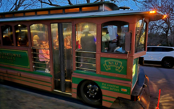 Photograph of a trolley with garlands and holiday lights